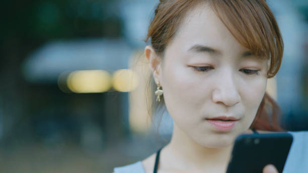 istock young Asian woman using smartphone 871431120