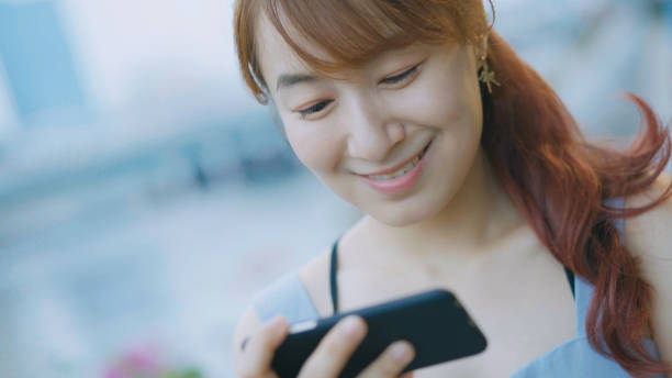 istock young Asian woman using smartphone 871431194