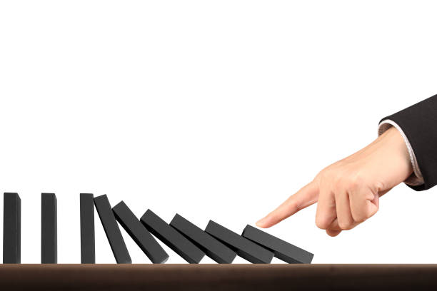 istock Hand Stopping domino concept 871435014