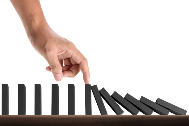 istock Hand Stopping domino concept 871435018