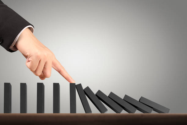 istock Hand Stopping domino concept 871435028