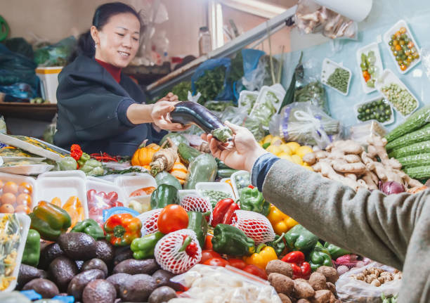istock Market Vendor Selling Vegetables 871437186