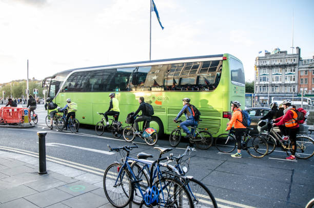 vista laterale delle persone in bicicletta nel centro di dublino in irlanda durante l'ora di punta al giorno d'autunno - republic of ireland dublin ireland bus city foto e immagini stock