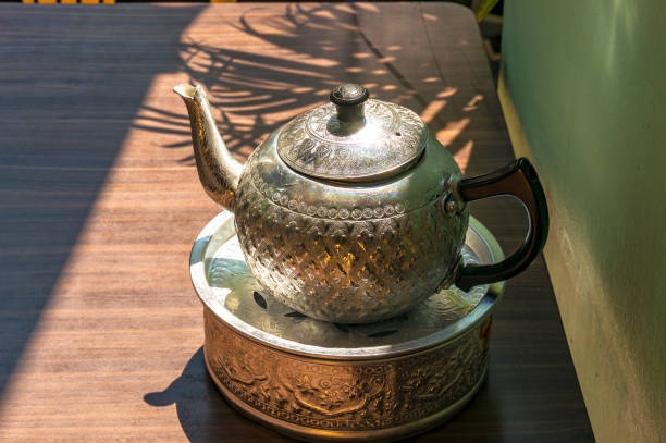 istock Shiny teapot on the table outdors 871444992