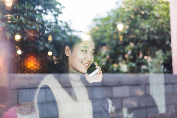 istock woman talking on cellphone in cafe 871448138