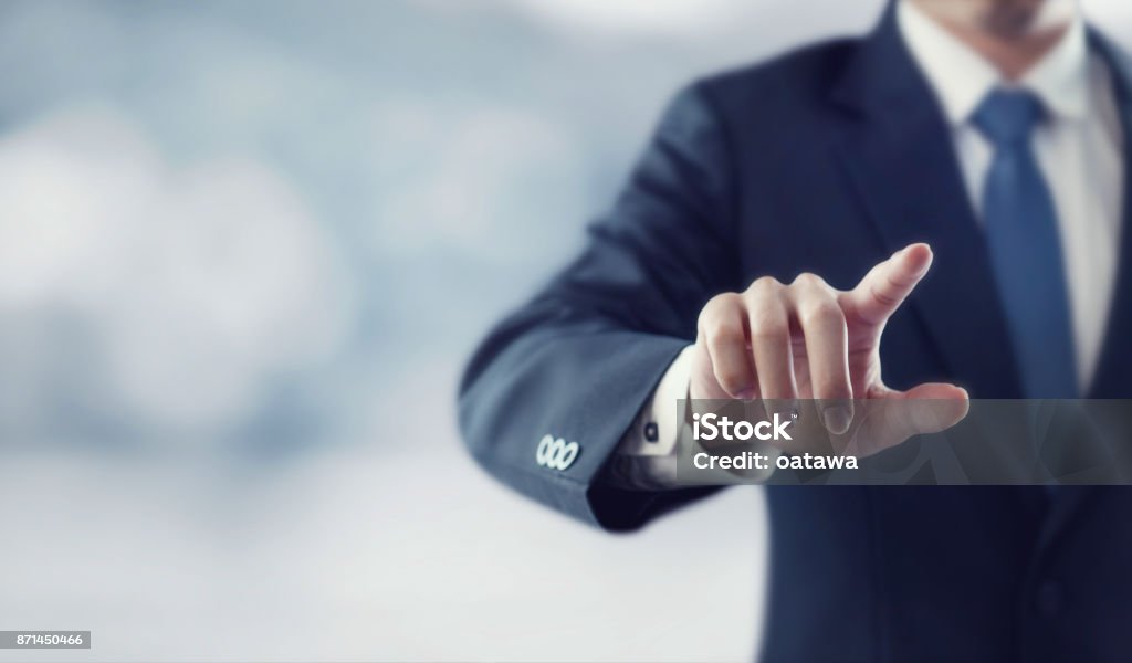 Businessman hand touching virtual screen Businessman hand touching virtual screen, modern background concept , can put your text  at the finger, copy space Pointing Stock Photo