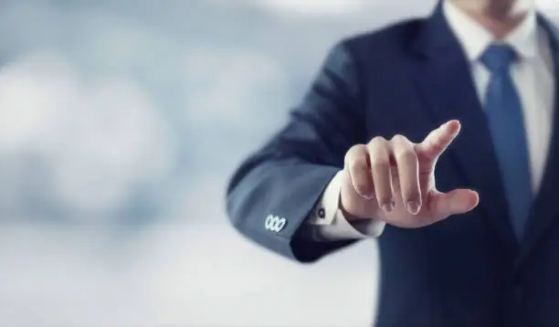 Photo of Businessman hand touching virtual screen