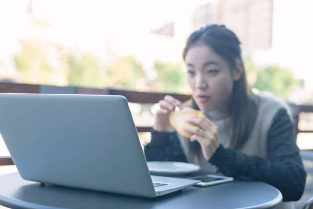 istock woman having lunch in cafe with laptop on table 871450844