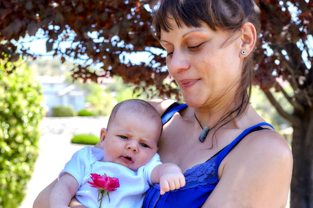 istock Mother smiling holding her Baby 871453680