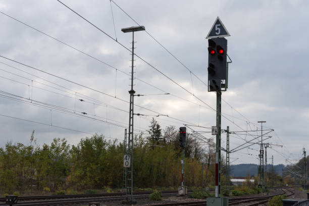 istock trainstation with train passing by and rails with infrastructure beside 871453994