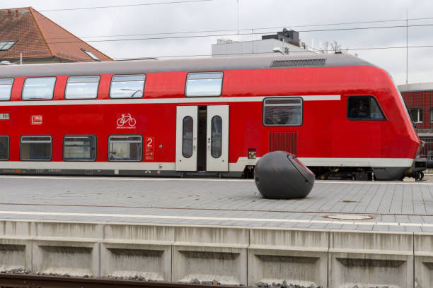 istock trainstation with train passing by and rails with infrastructure beside 871454016