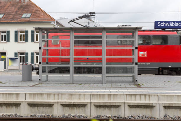 istock trainstation with train passing by and rails with infrastructure beside 871454052