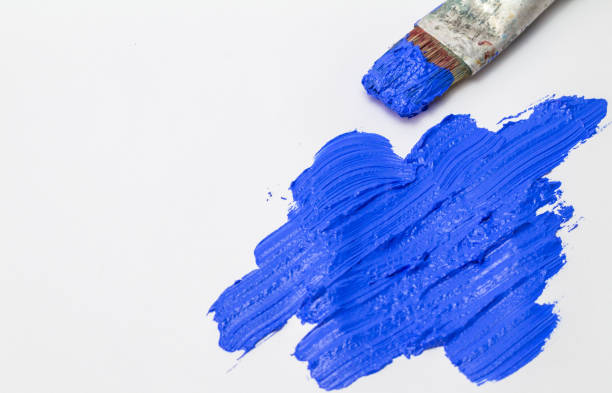 istock Abstract ultramarine blue brush stroke texture with old used paint brush on white background 871454152