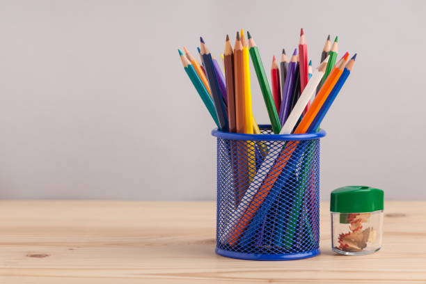 istock Colored pencils in the blue box on gray background 871457492