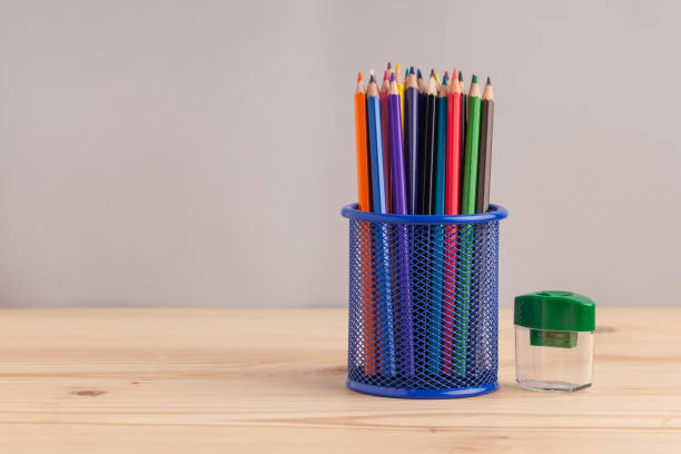 istock Colored pencils in the blue box on gray background 871457600