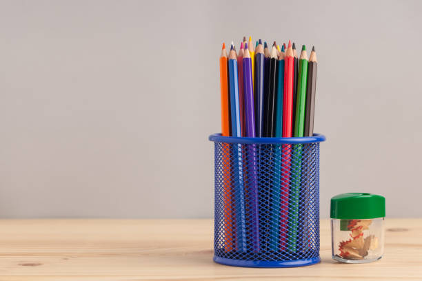 istock Colored pencils in the blue box on gray background 871457672