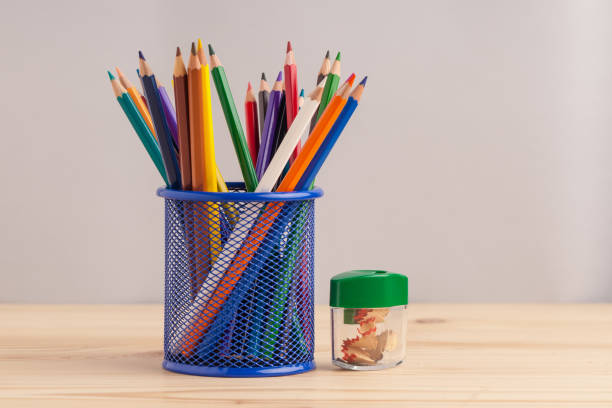istock Colored pencils in the blue box on gray background 871457692
