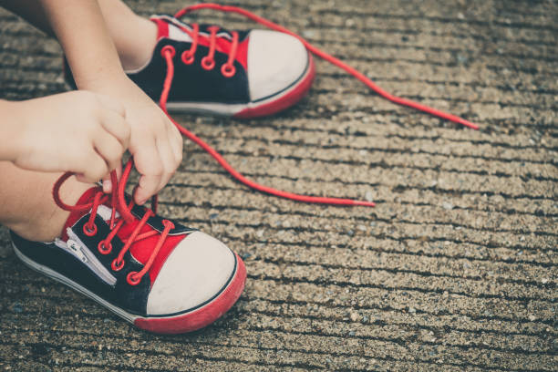 istock youth sneakers on boy legs on road 871461572