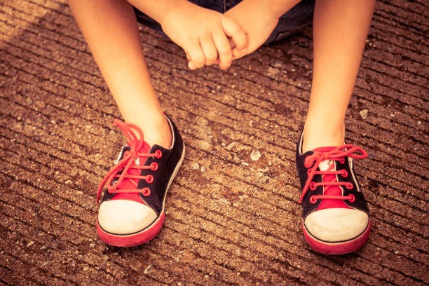 istock youth sneakers on boy legs on road 871461608