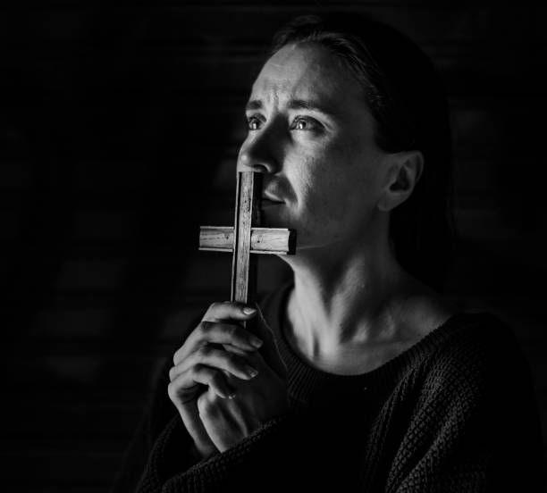 Woman Holding Cross Praying for God
