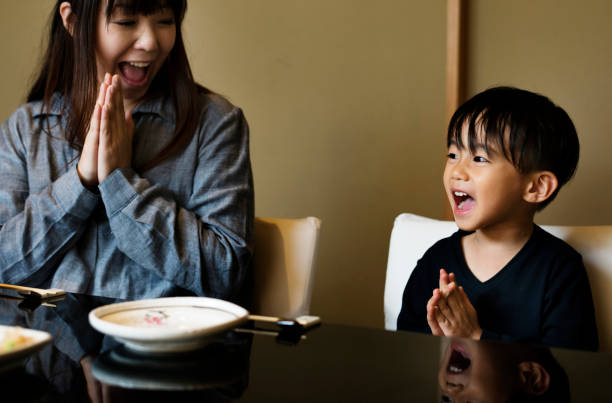istock Japanese mother and son praying 871464698