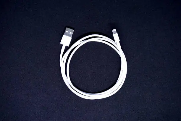 Photo of White USB Cable on Black Background Top View