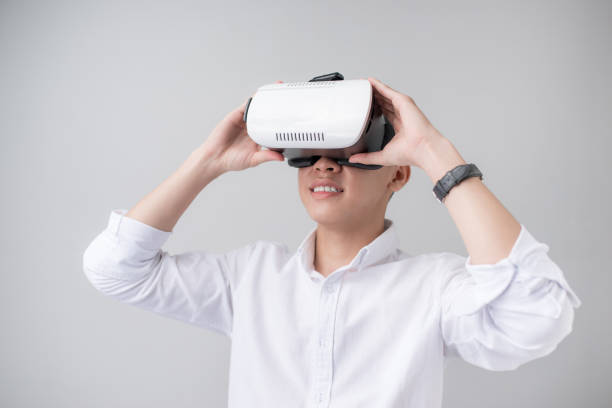 istock Excited asian man in a VR goggles and gesturing with his hands 871471066
