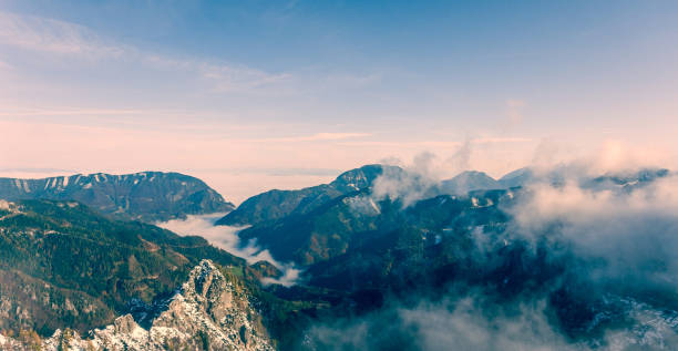 istock Aerial view of forest valleys bellow mountains. 871474954