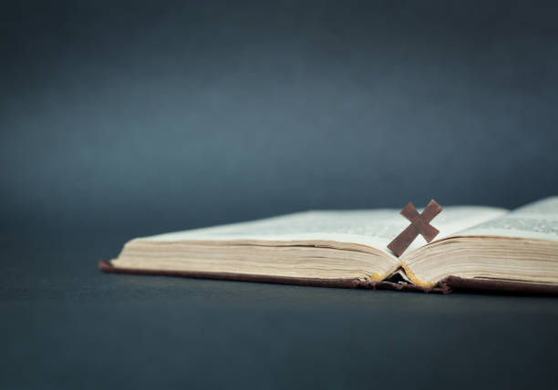 istock Cross and bible on a blue background. 871479444