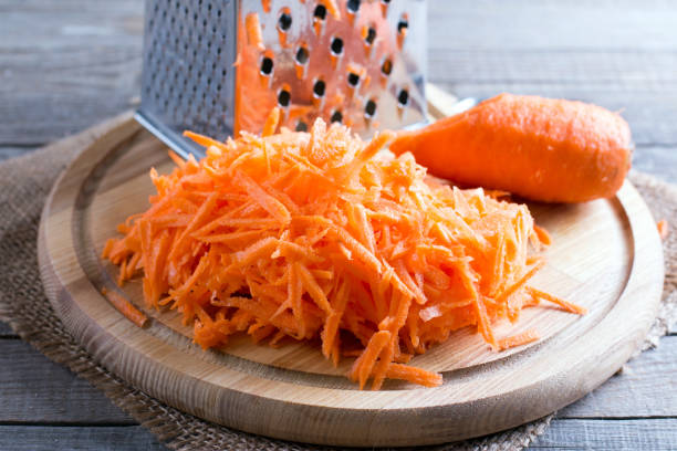 Carrots grated straw on a cutting board Carrots grated straw on a cutting board grated stock pictures, royalty-free photos & images