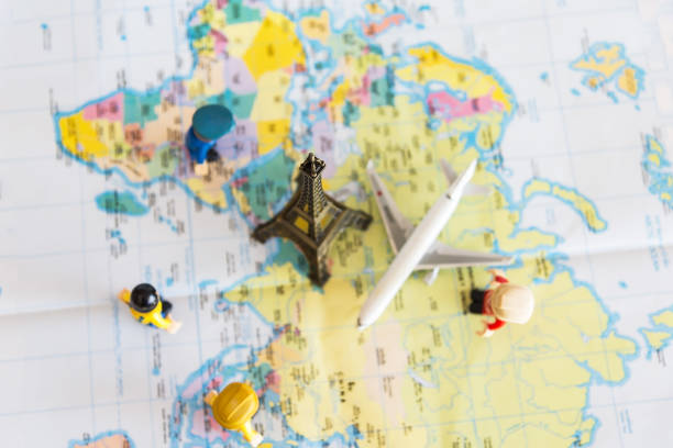 istock top view Miniature Group traveler with backpack standing on wold map for travel around the world. Travel Concept. 871482260