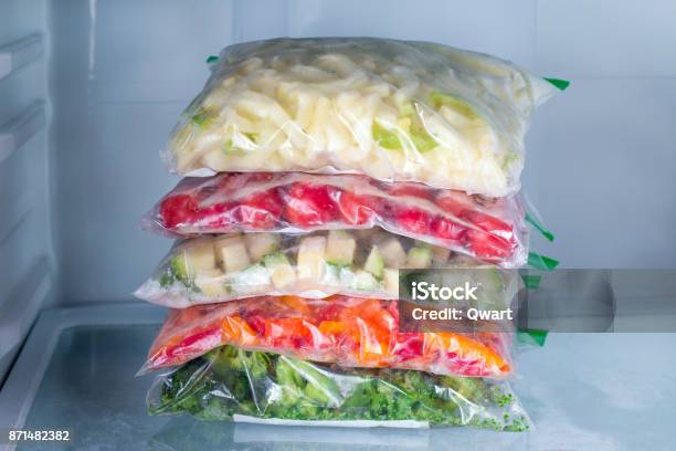 Bags With Frozen Vegetables In Refrigerator Closeup Stock Photo - Download Image Now