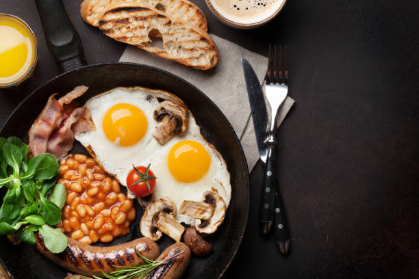 istock English breakfast. Fried eggs, sausages, bacon 871483152