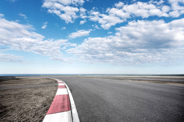 istock empty asphalt road with blue sea in blue sky 871486176