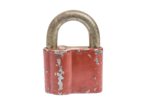 Old vintage red padlock. Close up image isolated on white background.