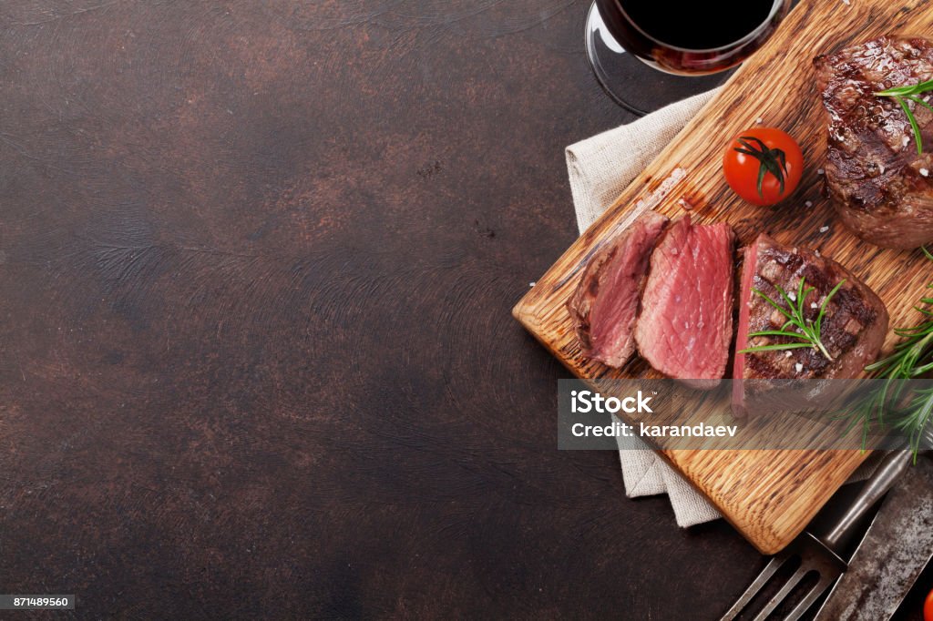 Grilled fillet steak with wine Grilled fillet steak with red wine on stone table. Top view with space for your text Meat Stock Photo