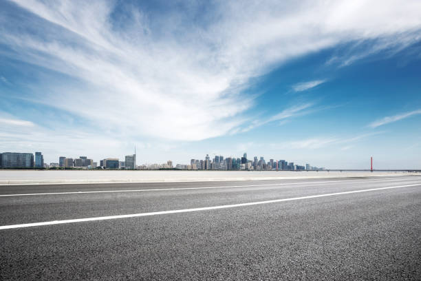istock empty asphalt road with modern bridge and buildings 871491128