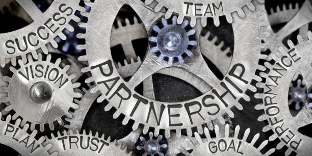 Metal Wheel Concept Macro photo of tooth wheel mechanism with Partnership related words imprinted on metal surface partnership stock pictures, royalty-free photos & images