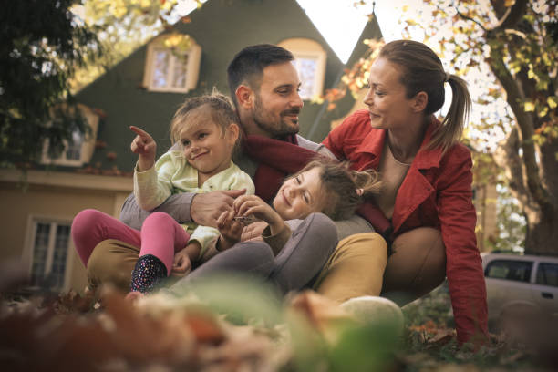 istock Parents at front of backyard with daughters enjoy. 871494014