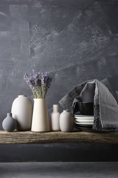 Neutral colored crockery on wooden shelf