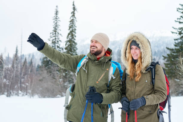 istock Fearless couple discussing route in mountains 871497104