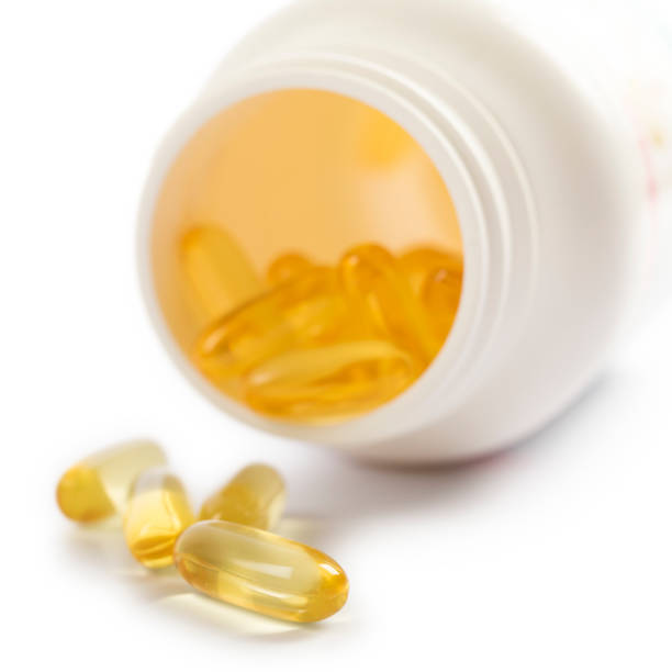 istock Nutritional supplement pills isolated on white background 871497468