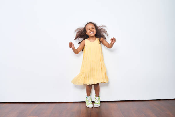 istock Excited little girl dancing 871498476