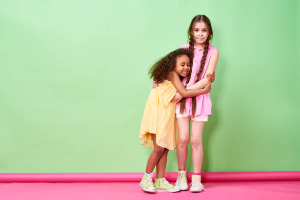 istock Cute African kid hugging girl 871498688