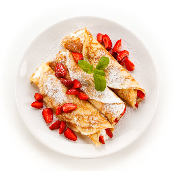 Crepes with strawberries and cream Crepes with strawberries and cream on white background crêpe pancake photos stock pictures, royalty-free photos & images