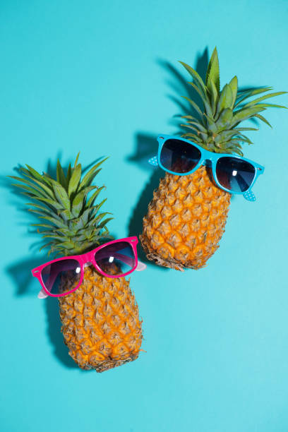 istock Funny pineapple in a sunglasses over blue background 871509284