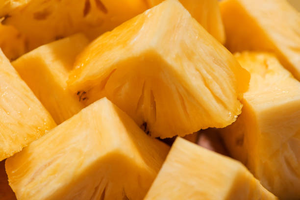 istock Tropical fruit concept. Cutted pineapple on the old wooden background. 871509674