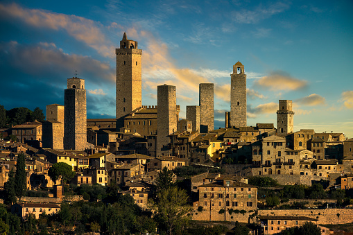 San Gimignano medieval town towers skyline and countryside landscape panorama at sunrise. Tuscany, Italy, Europe.