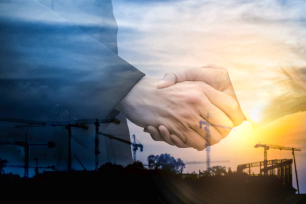 istock Double exposure. Businessman handshake on industrial background. 871516878