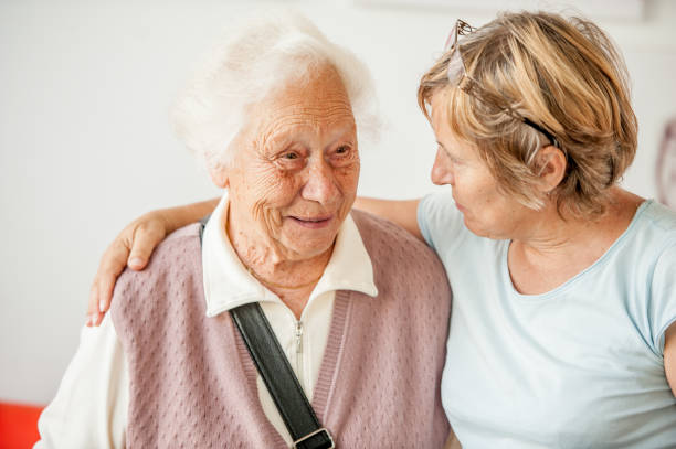 Tenderness Between Senior Mother And Mature Daughter stock photo